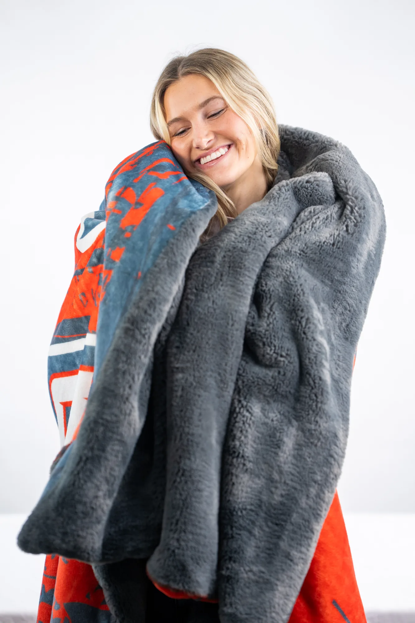 A person wrapped in a plush keepsake-weight practice blanket at home